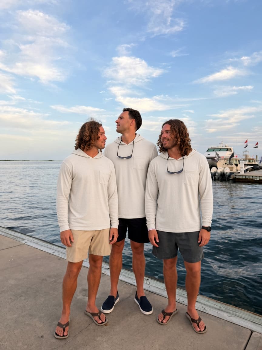 Twin Fin founders on a marina dock wearing the sun hoodie
